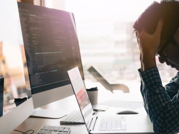 Worker strained at their computer