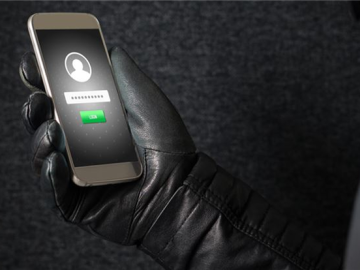 A gloved hand holding a secured phone