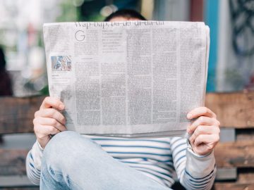 A person reading a newspaper