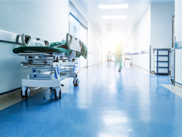 healthcare image, a bed in an empty hospital hallway