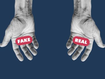 Two hands that look identical have the words "Fake" written over the left hand and "Real" written over the right hand