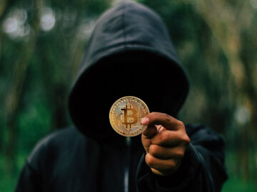 Hacker holding a bitcoin