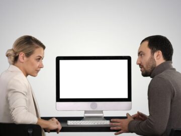 man and woman sharing a Mac